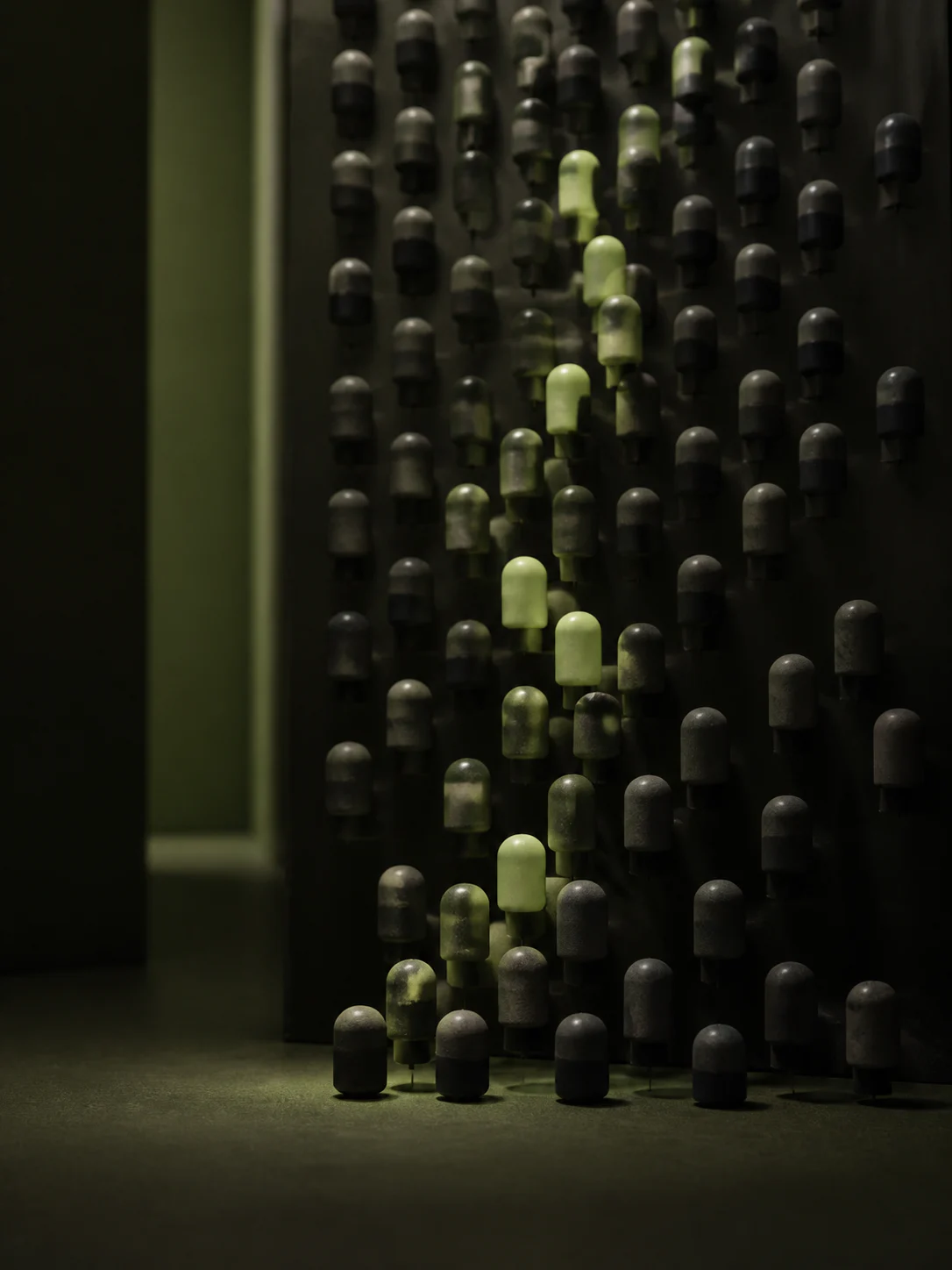 Rows of dark ceramic tokens with a moss-green path through them